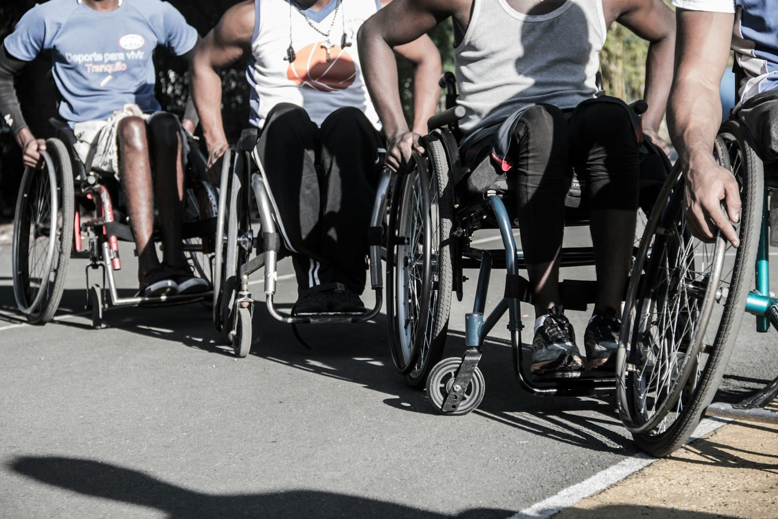 Diego driving forward in a sport wheelchair during a competitive match.