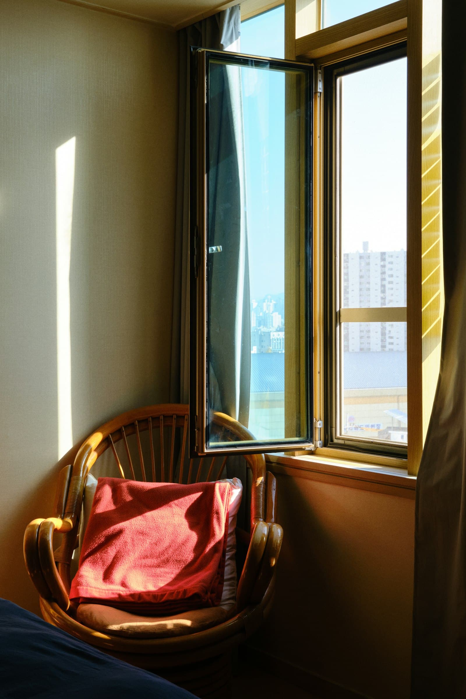 Marisa taking a quiet moment to herself by a window, resting.