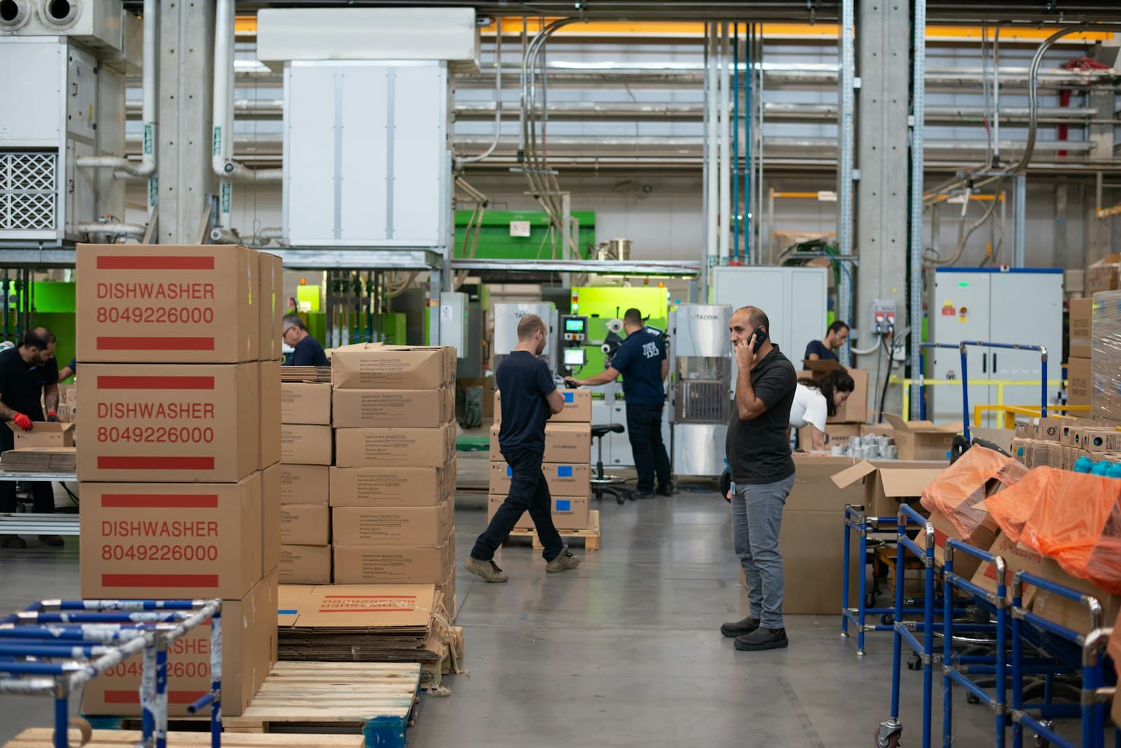 Workers in a modern logistics facility collaborating on the floor.